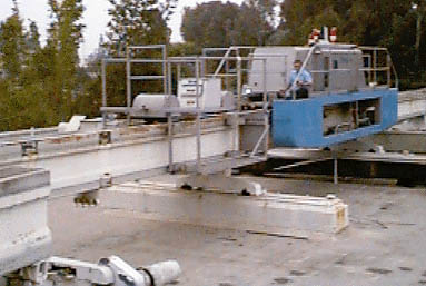 Blue Tractor and trailer switching shop beams